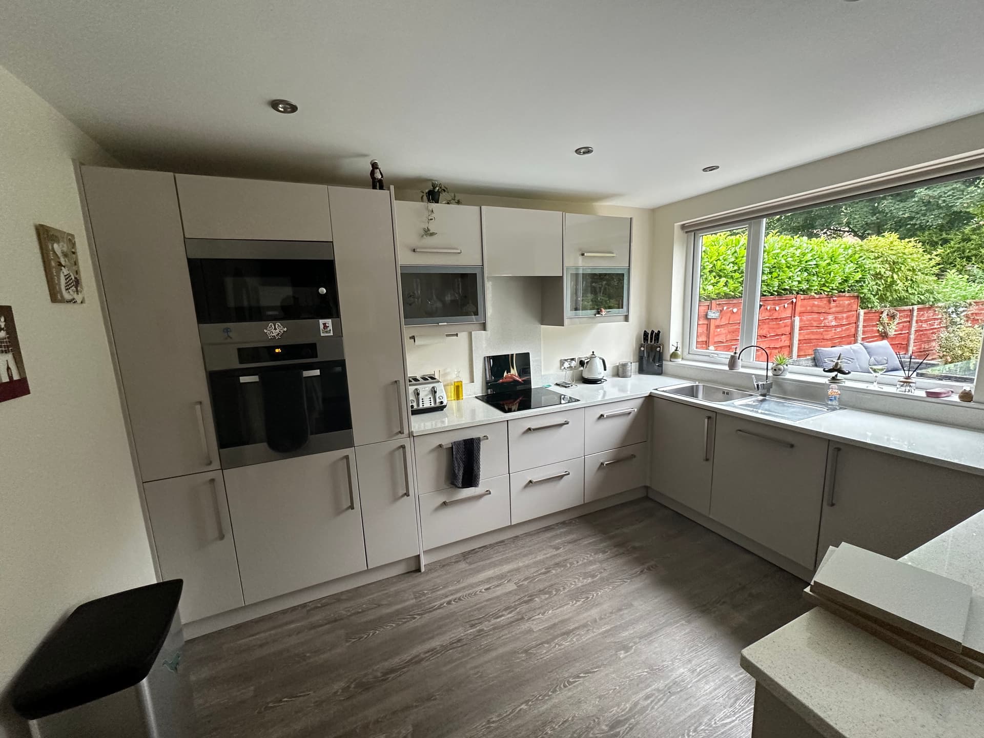 Kitchen before respray - white and grey dated cabinets in Urmston
