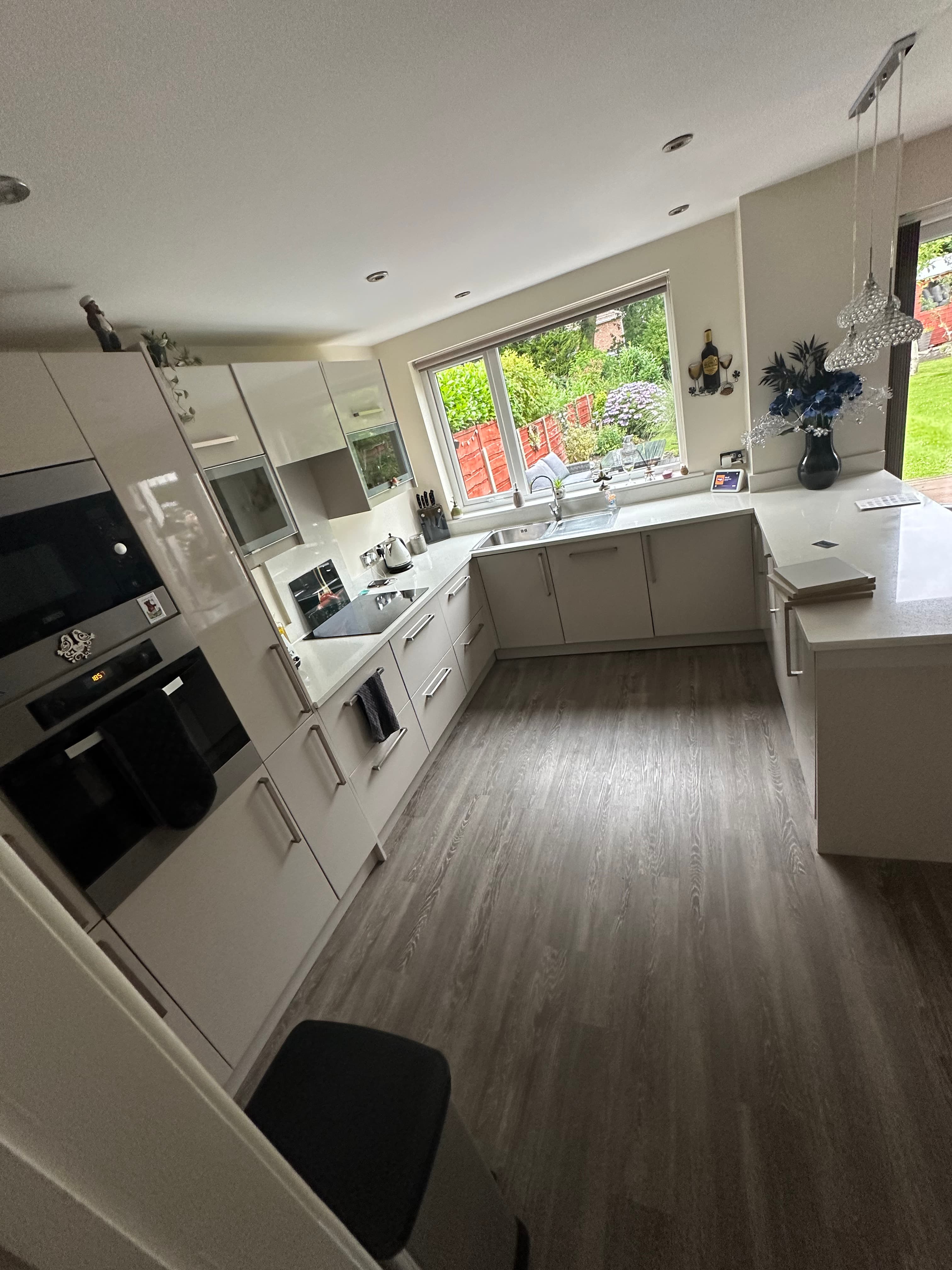 Premium workshop respray on a Howdens kitchen in hague blue, photographed 4 years after completion in St Helens